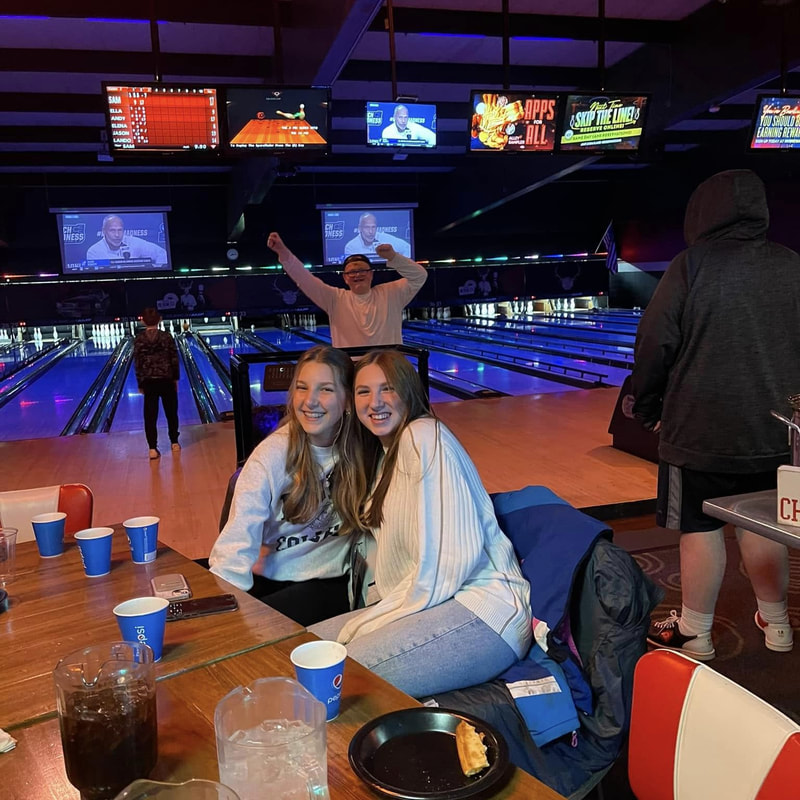 teenagers smiling at club bowling event