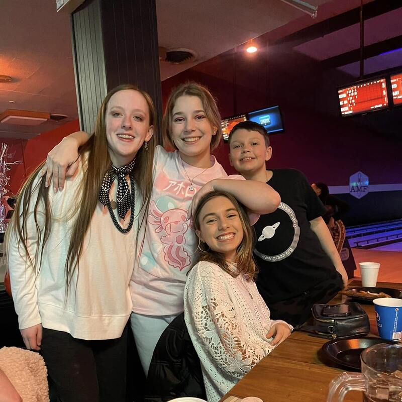 kids smiling at bowling alley